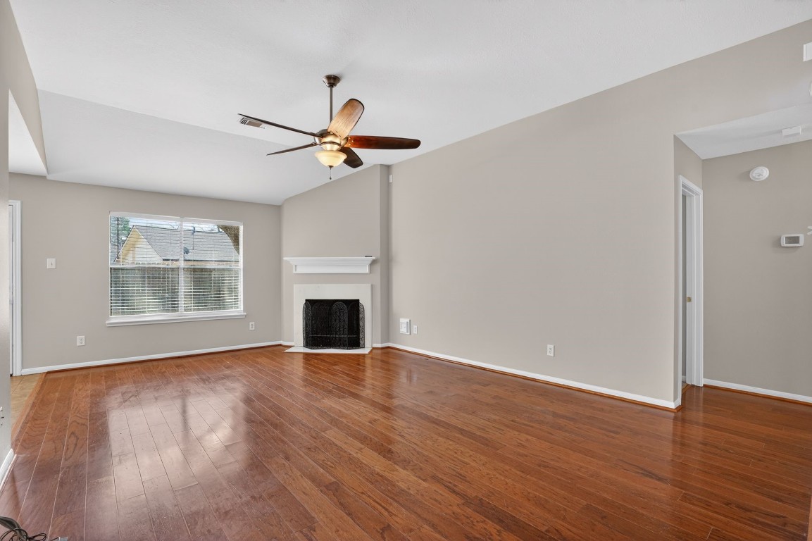 18622 Timbers Drive Humble, TX 77346 - Photo 6 of 34 a view of an empty room with wooden floor and a window