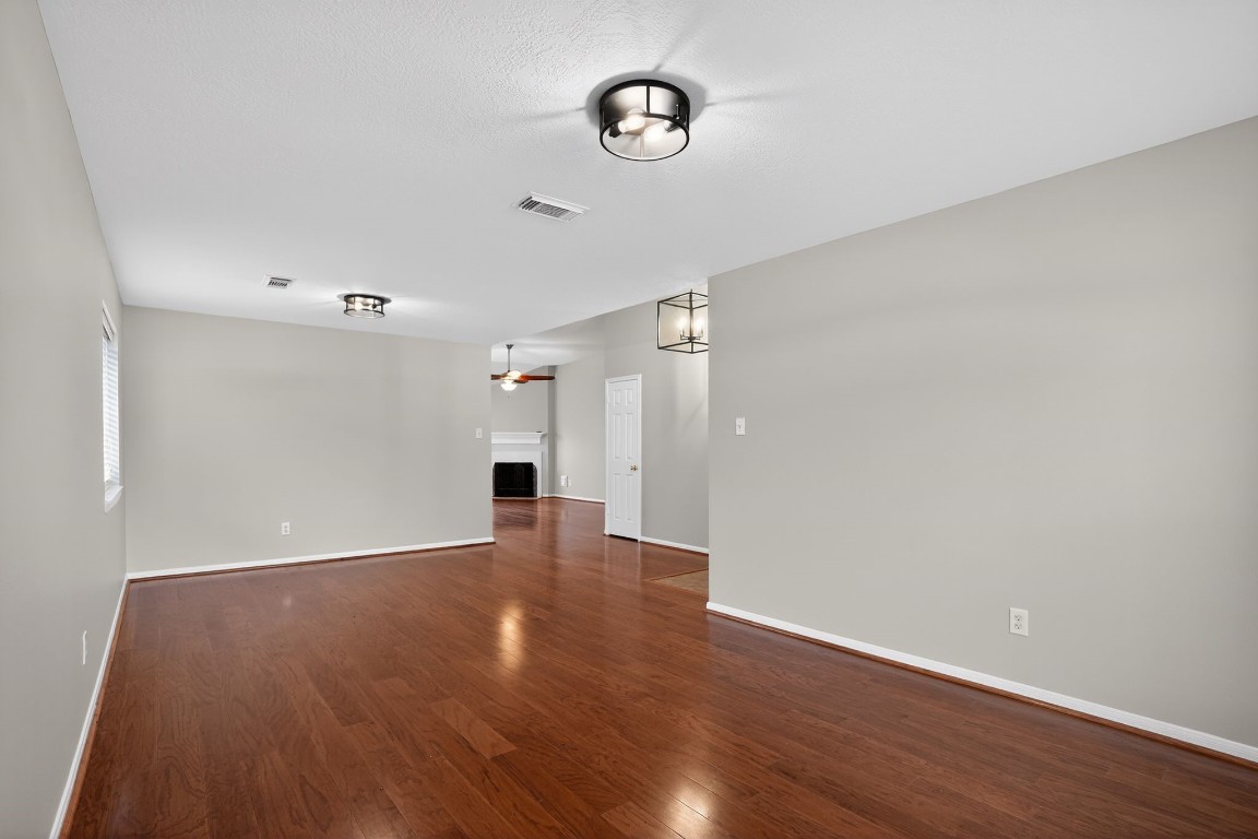 18622 Timbers Drive Humble, TX 77346 - Photo 8 of 34 a view of an empty room with wooden floor and a window
