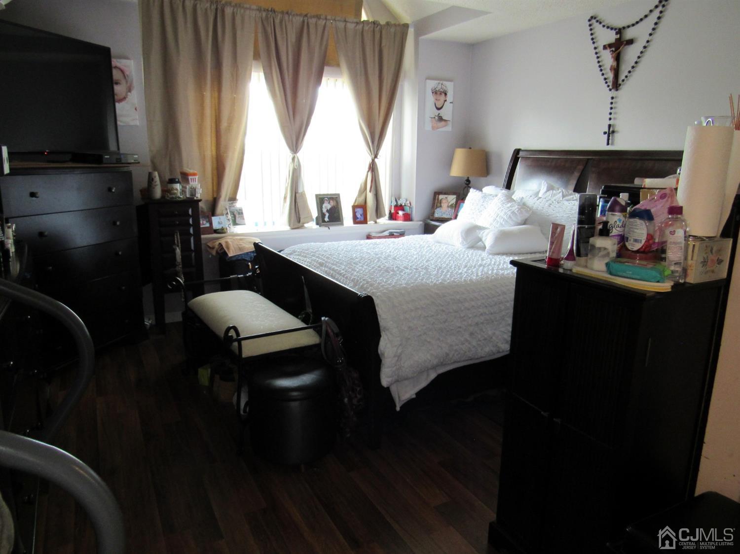 333 Edpas Road New Brunswick, NJ 08901 - Photo 17 of 24 a bedroom with a bed and a flat tv screen