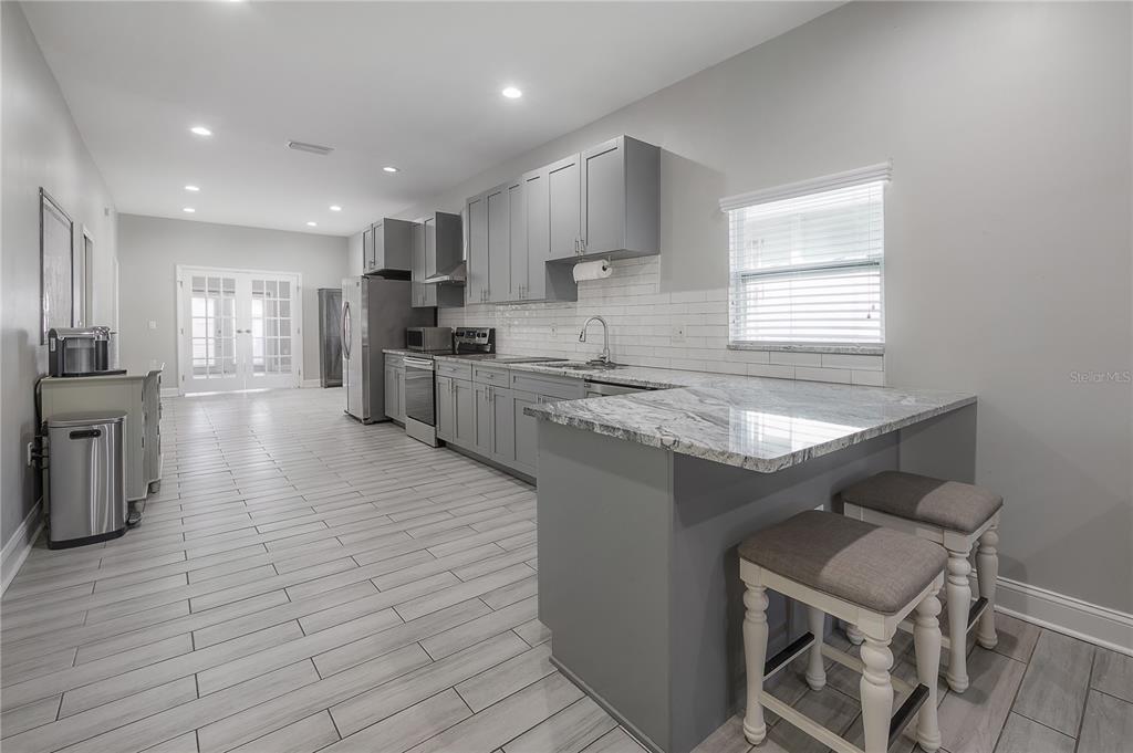 2341 West Chestnut Street Tampa, FL 33607 - Photo 8 of 42 a kitchen with stainless steel appliances granite countertop a sink counter space cabinets and a counter top space
