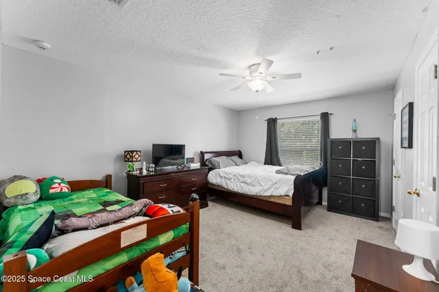 a bedroom with a bed dresser and a chair