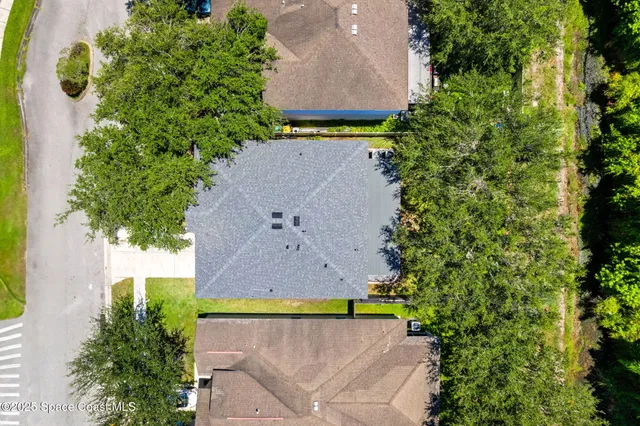 an aerial view of a house with a yard and a outdoor space