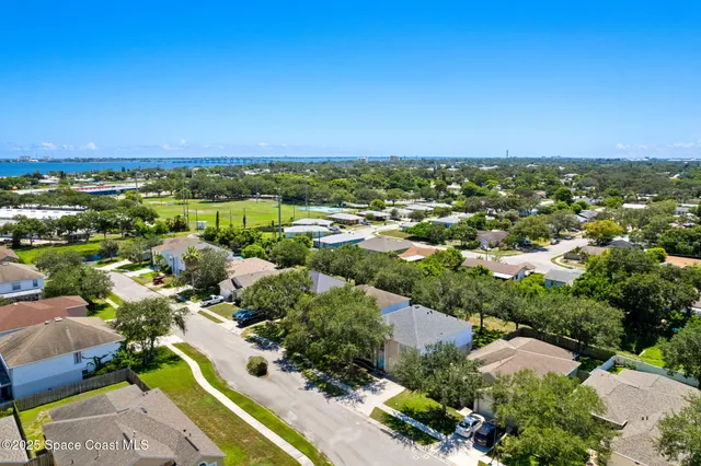an aerial view of residential houses with outdoor space