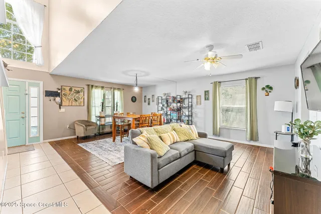 a living room with furniture and wooden floor