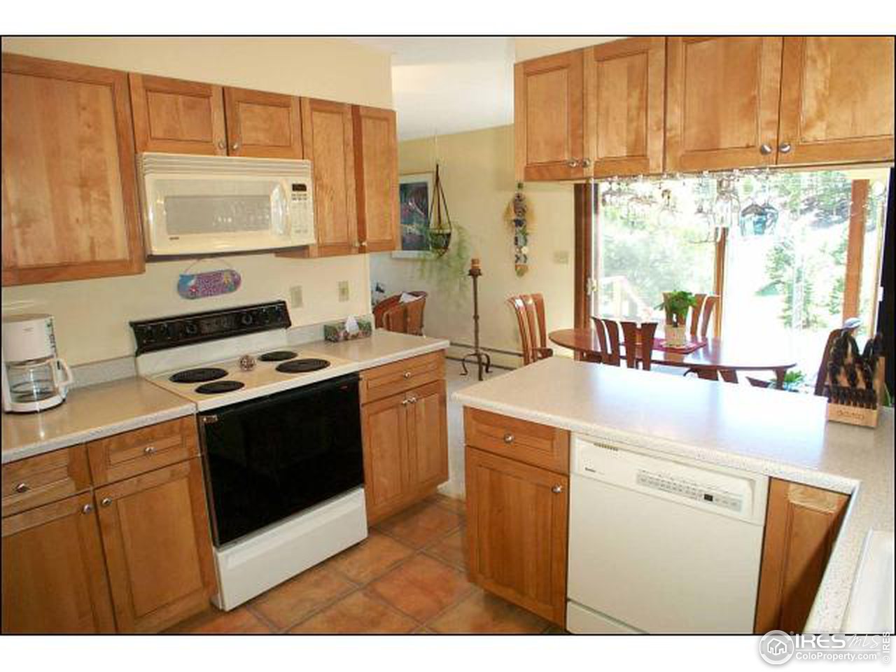 303 Deer Trail Road Boulder, CO 80302 - Photo 3 of 9 a kitchen with a sink stove and cabinets