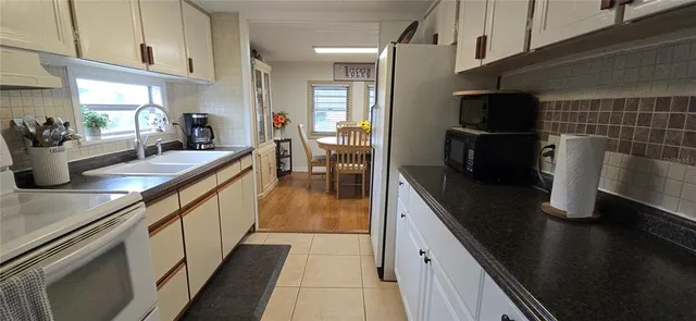 a bathroom with a double vanity sink toilet and shower