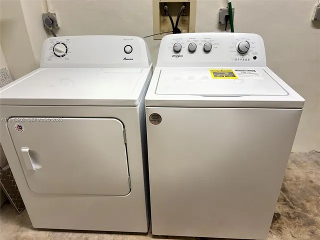 a view of house with a yard and sitting area