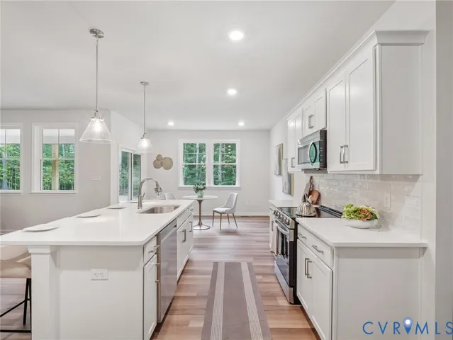 a kitchen with a sink a counter top space and appliances