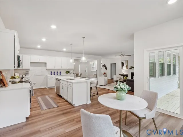 a view of a dining room with furniture and wooden floor