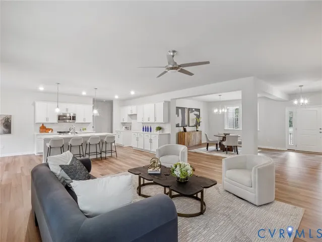 a living room with furniture and kitchen view