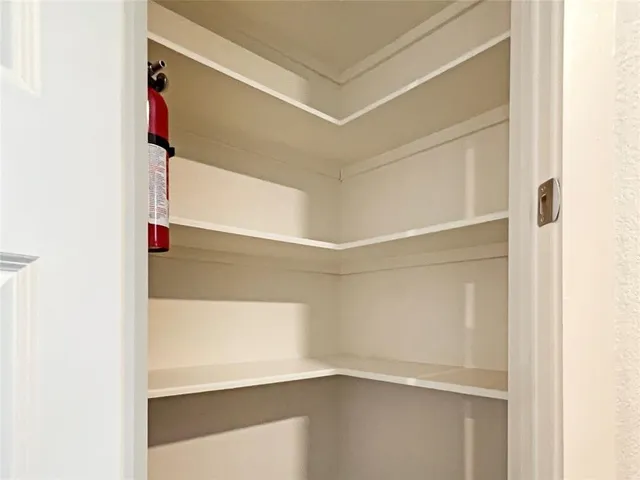 a view of walk in closet with clothes