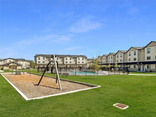 a view of a big yard with a house in the background