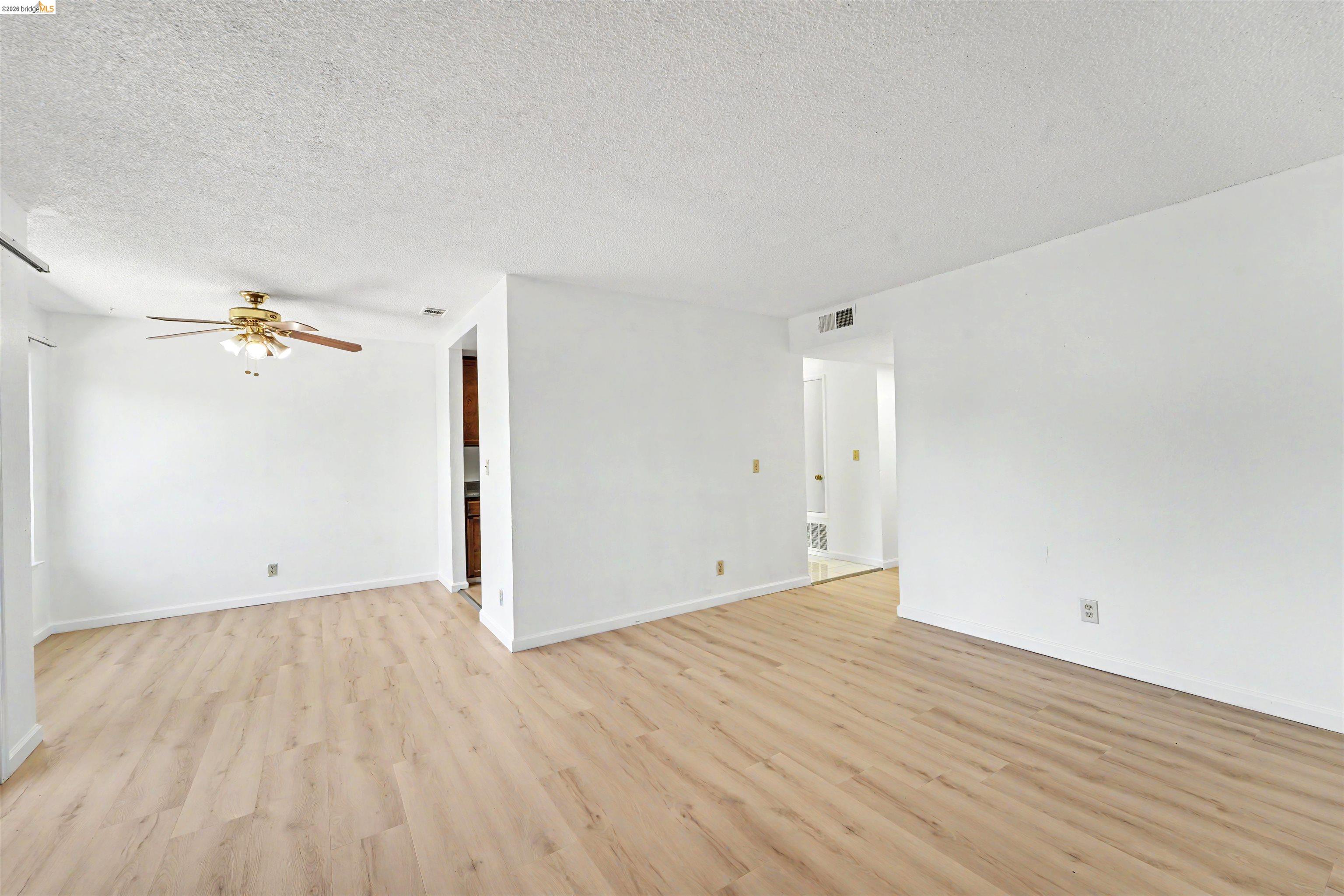 4186 San Pablo Dam Road, Unit A El Sobrante, CA 94803 - Photo 25 of 34 Spacious interior featuring light wood-finish flooring, white walls, and a ceiling fan with integrated lighting