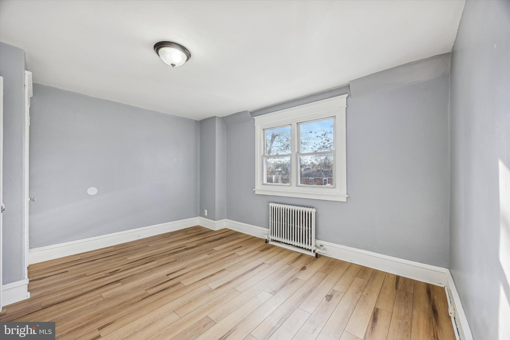 433 Copley Road Upper Darby, PA 19082 - Photo 21 of 35 wooden floor in an empty room with a window