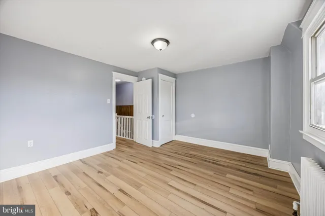 a view of a room with wooden floor and windows