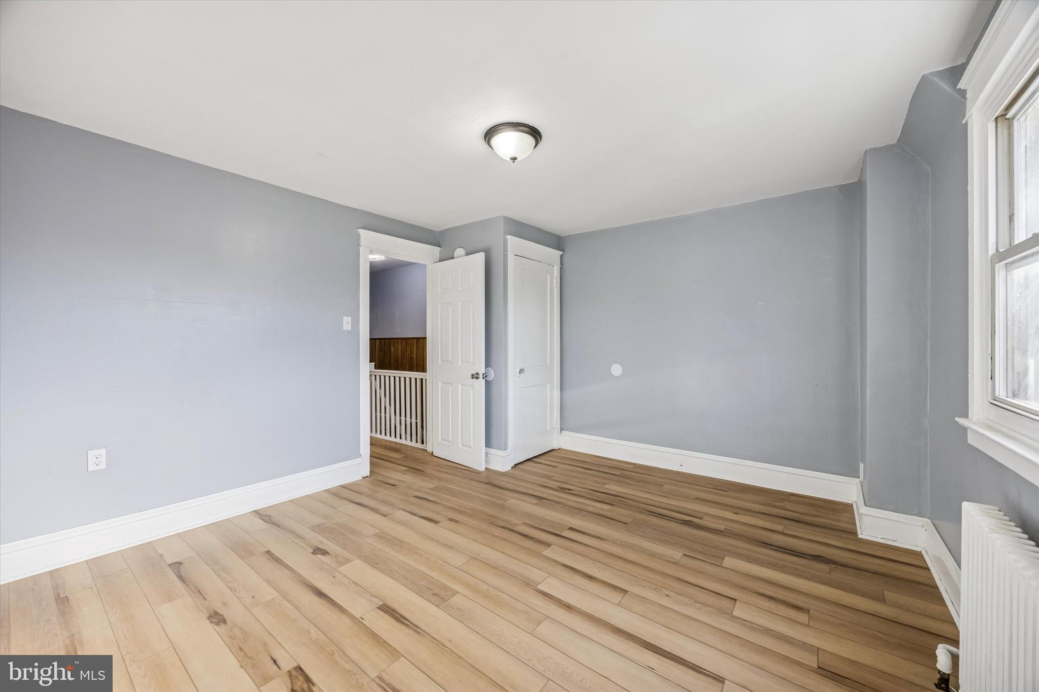 433 Copley Road Upper Darby, PA 19082 - Photo 22 of 35 a view of an empty room with wooden floor and a window