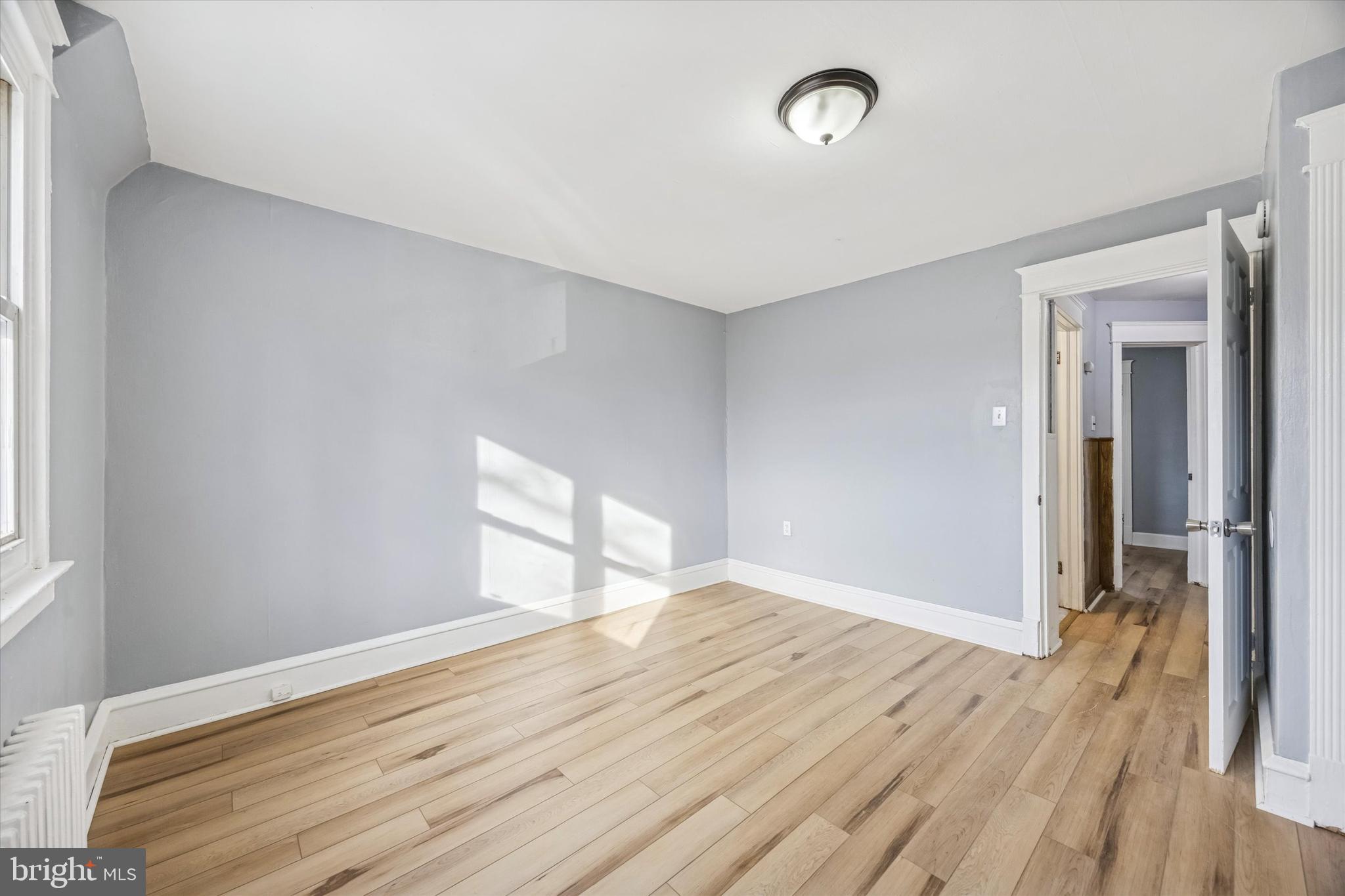 433 Copley Road Upper Darby, PA 19082 - Photo 23 of 35 a view of an empty room with wooden floor and a window