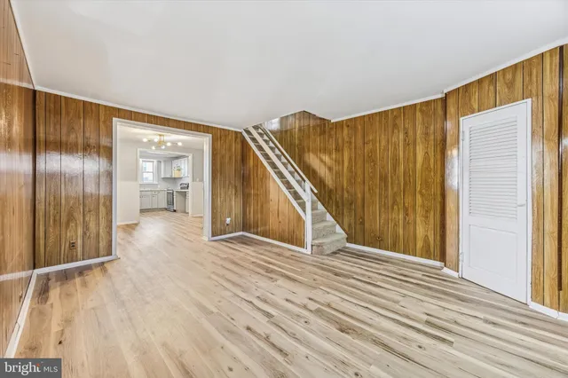 a view of a big room with wooden floor and windows