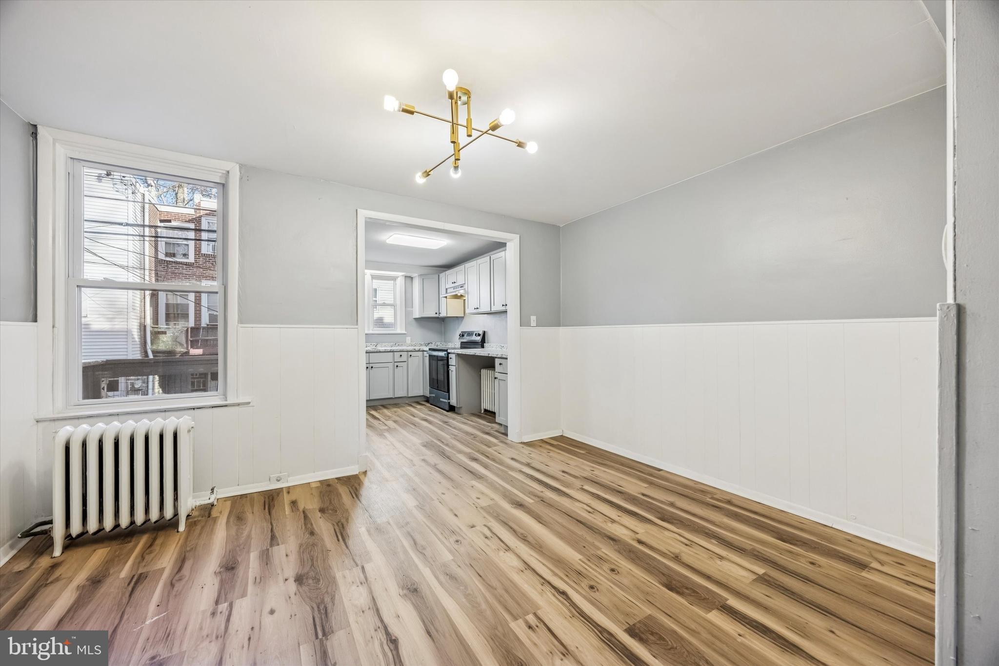 433 Copley Road Upper Darby, PA 19082 - Photo 9 of 35 a view of a room with wooden floor and kitchen view