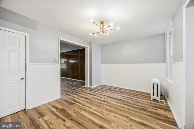 a view of a room with wooden floor