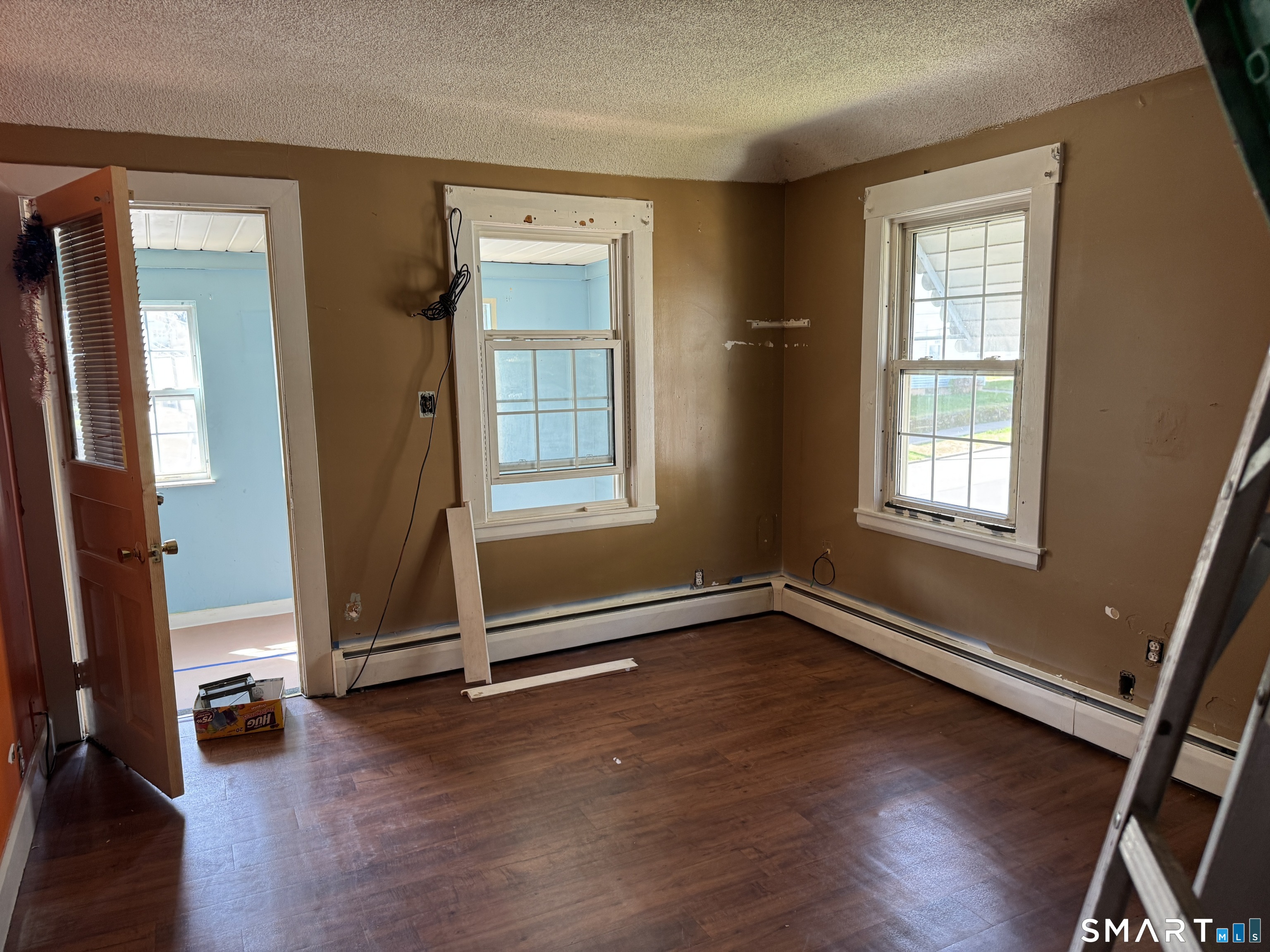 138 Greene Street Bristol, CT 06010 - Photo 18 of 32 an empty room with wooden floor and windows