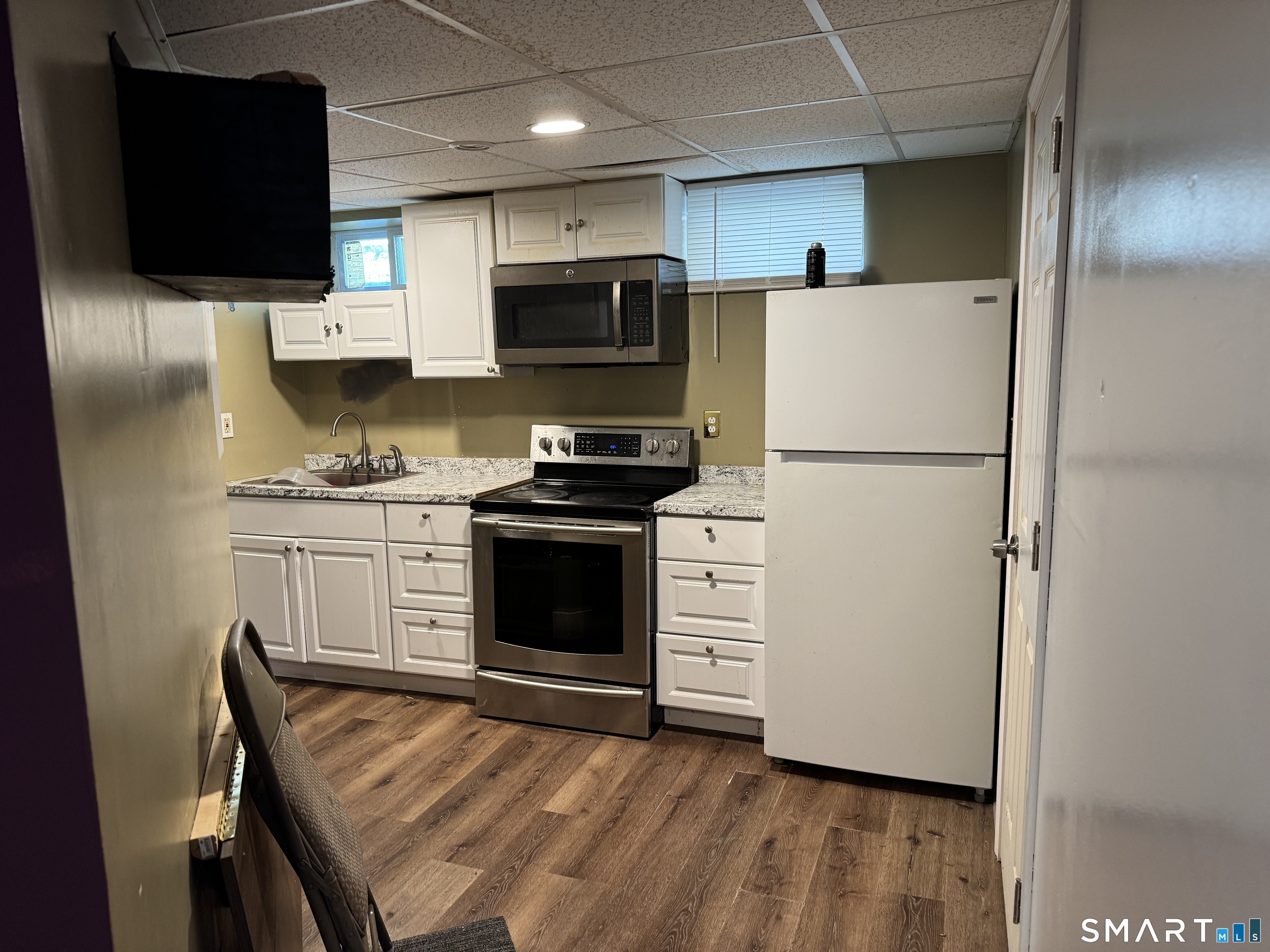 138 Greene Street Bristol, CT 06010 - Photo 28 of 32 a kitchen with stainless steel appliances a refrigerator stove and microwave