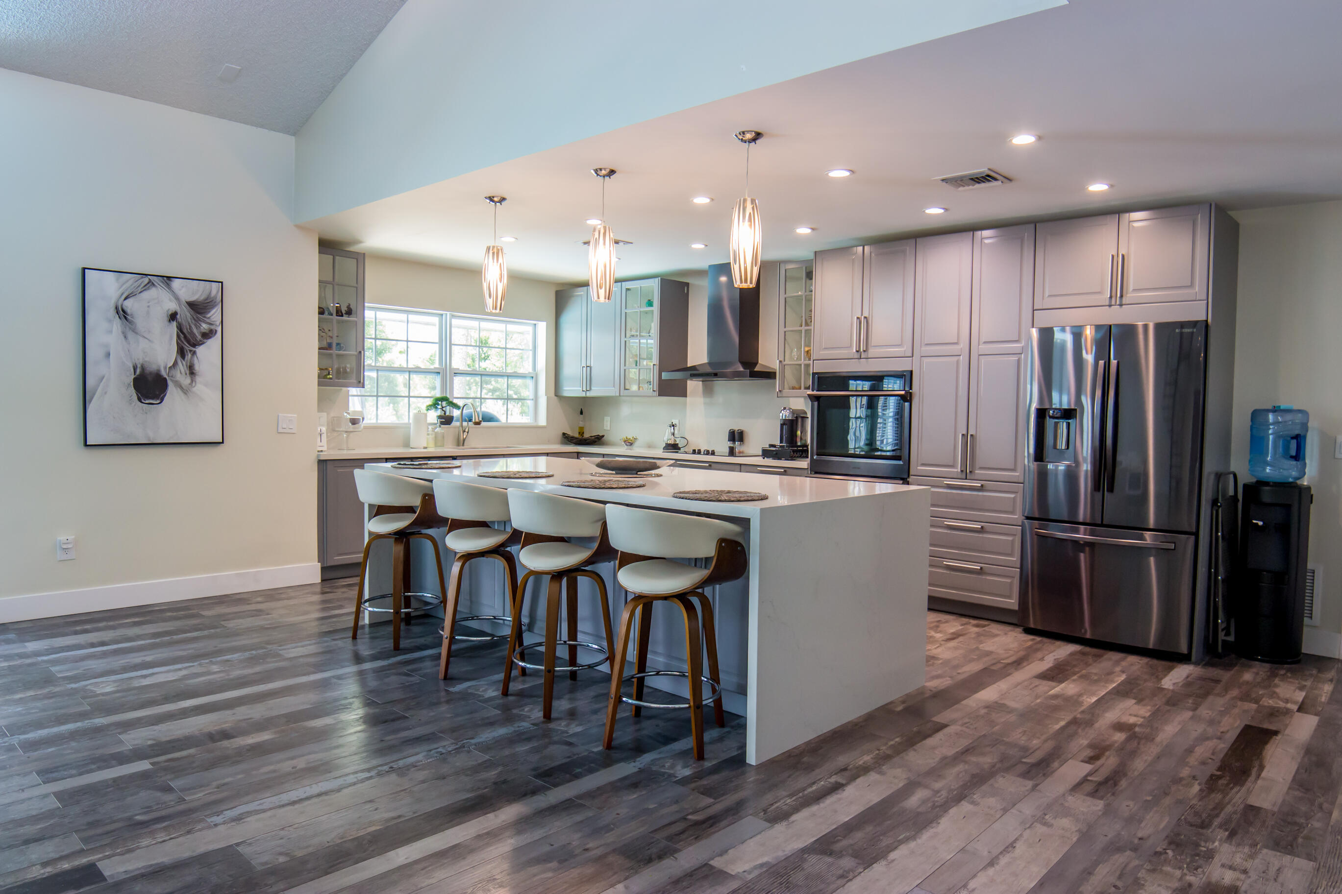 661 West Rambling Drive Wellington, FL 33414 - Photo 12 of 33 a kitchen with a refrigerator a dining table and chairs