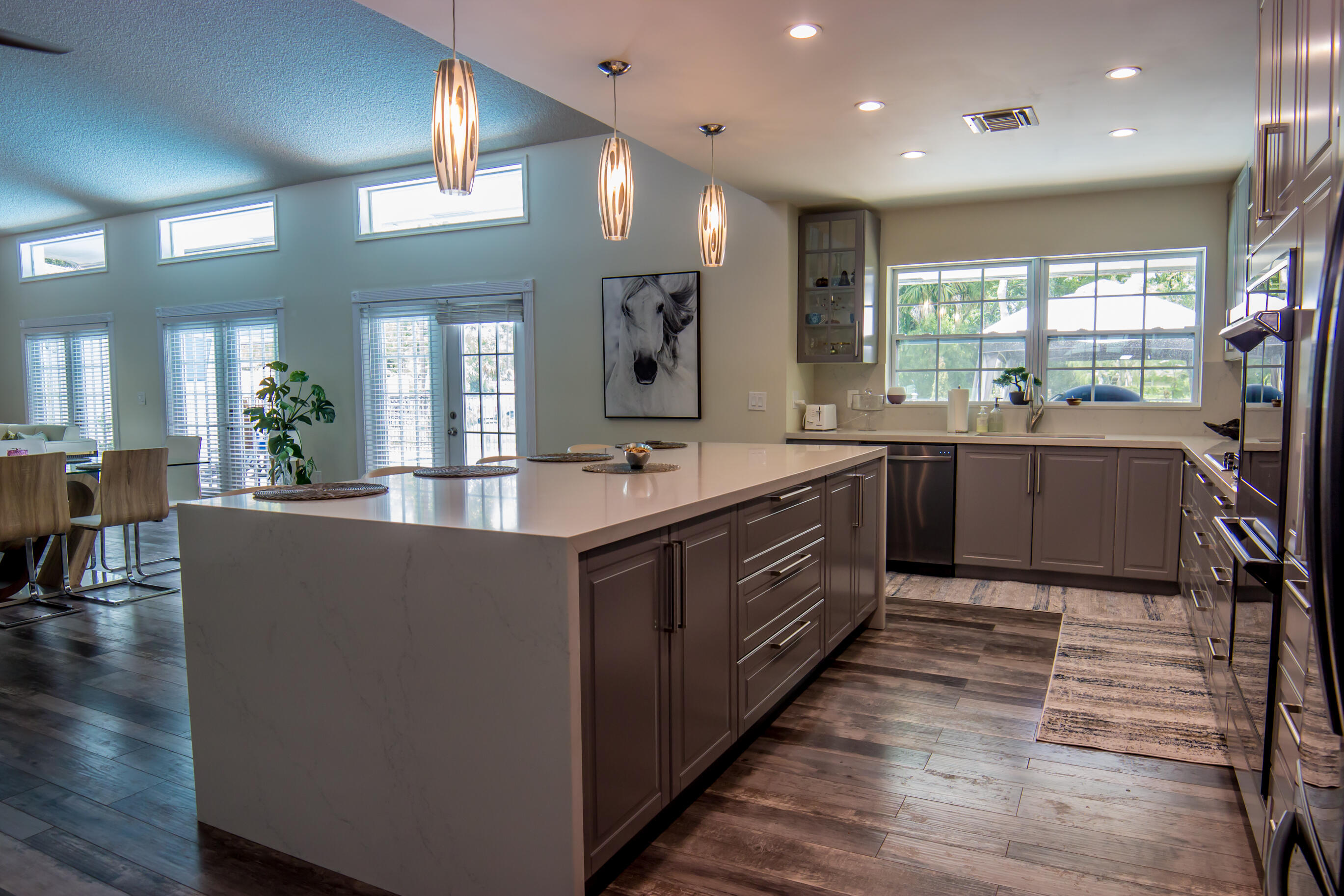 661 West Rambling Drive Wellington, FL 33414 - Photo 13 of 33 a large kitchen with stainless steel appliances kitchen island granite countertop a large counter top and sink