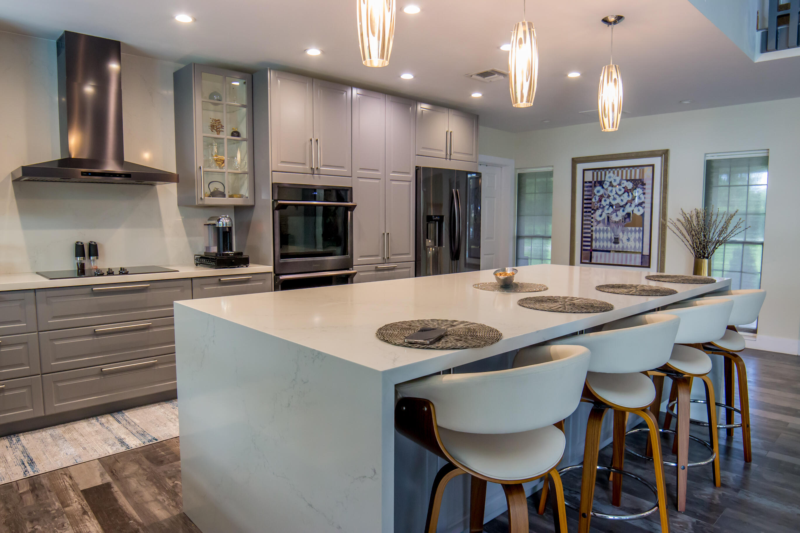 661 West Rambling Drive Wellington, FL 33414 - Photo 14 of 33 a kitchen with kitchen island granite countertop a sink and stainless steel appliances
