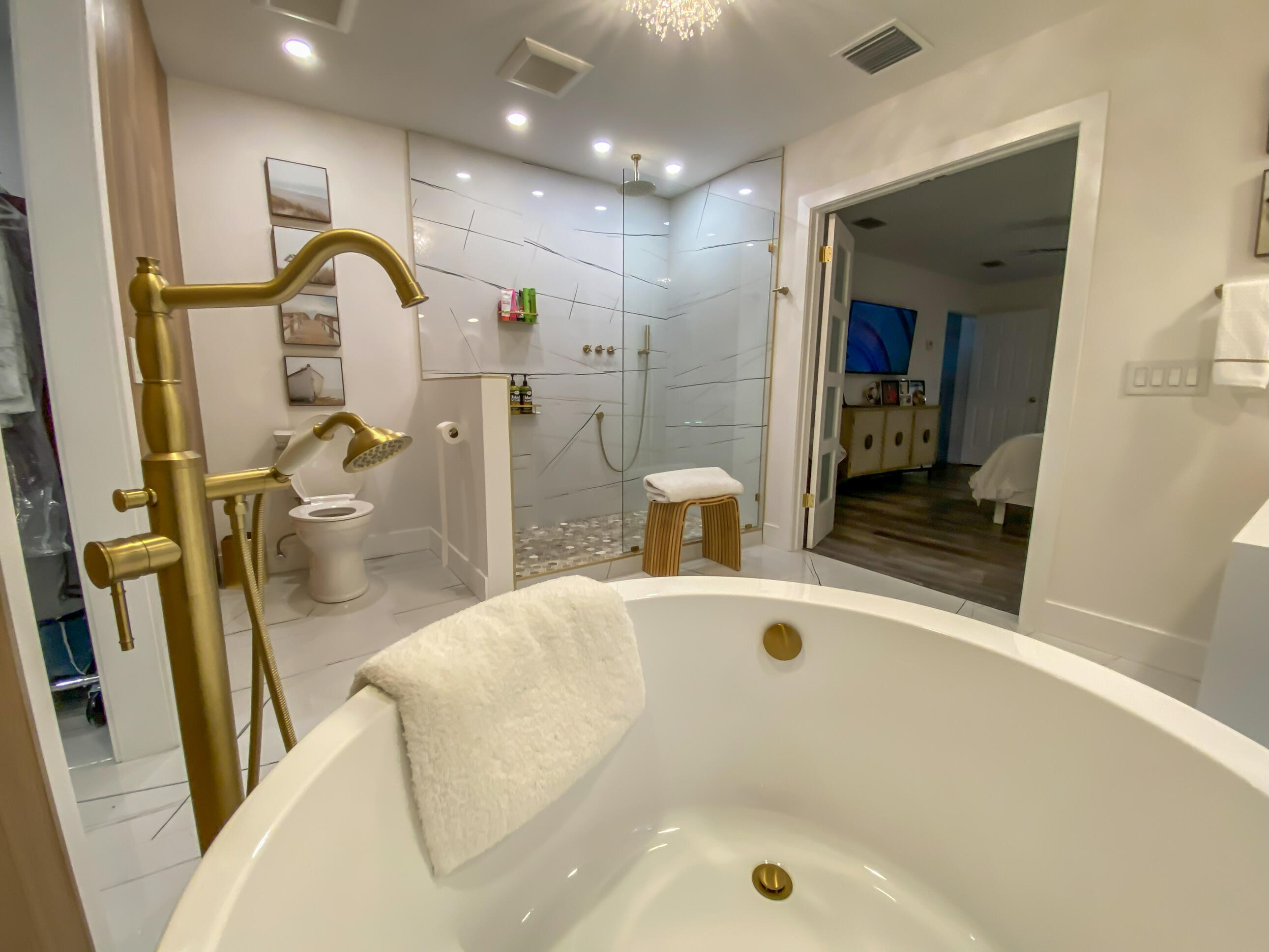 661 West Rambling Drive Wellington, FL 33414 - Photo 28 of 33 a bathroom with a tub sink a mirror and shower