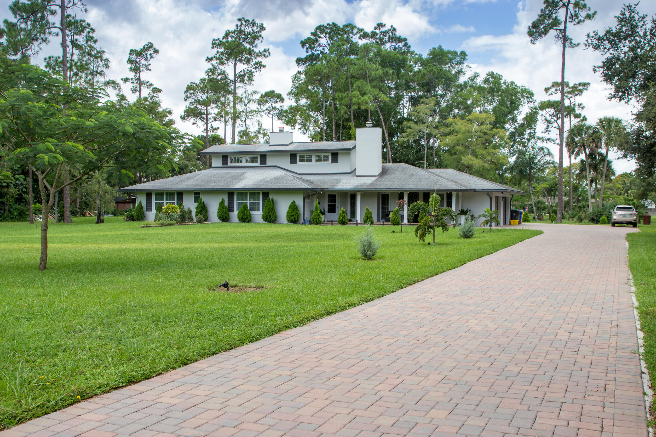 661 West Rambling Drive Wellington, FL 33414 - Photo 3 of 33 a front view of a house with a yard