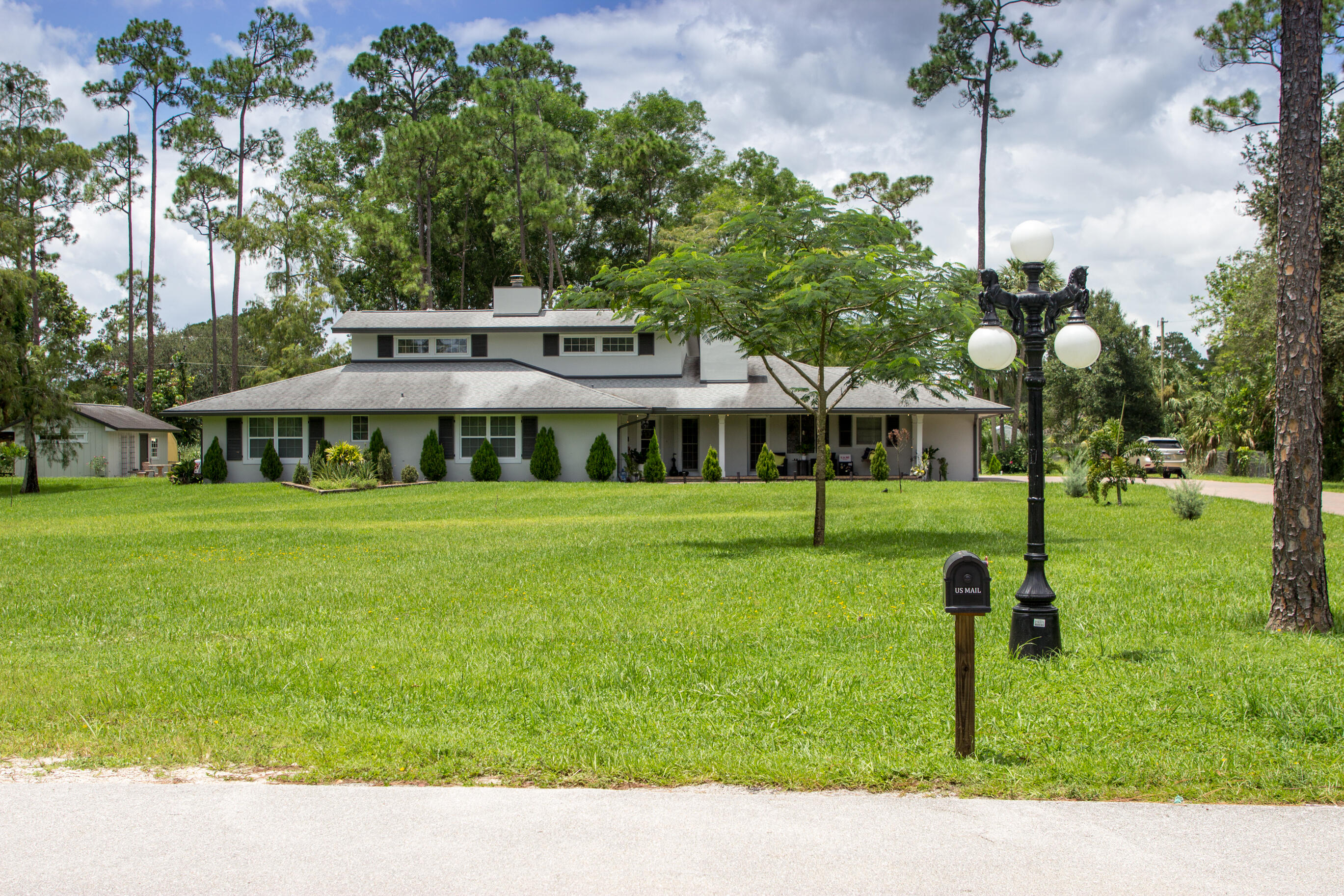 661 West Rambling Drive Wellington, FL 33414 - Photo 4 of 33 a house view with a garden space
