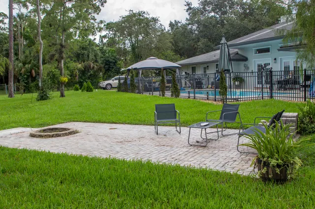 a view of a chair and table in the garden