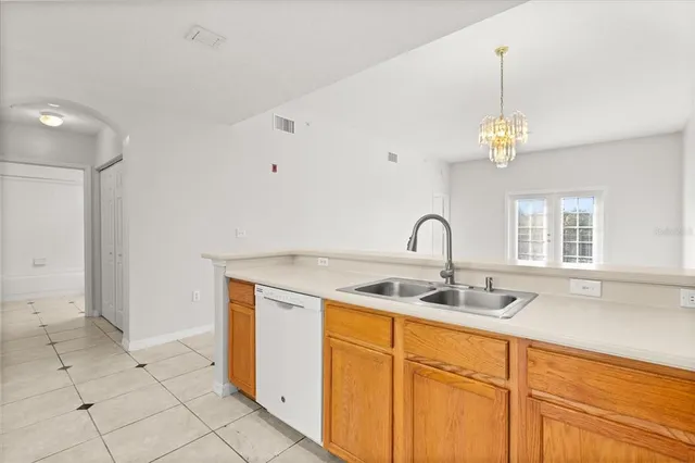 a kitchen with stainless steel appliances granite countertop a sink and a white cabinets