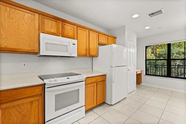 a kitchen with stainless steel appliances granite countertop a refrigerator sink and stove