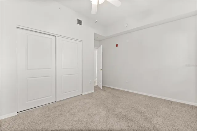 an empty room with a ceiling fan