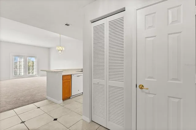 a view of an empty room with window and cabinet