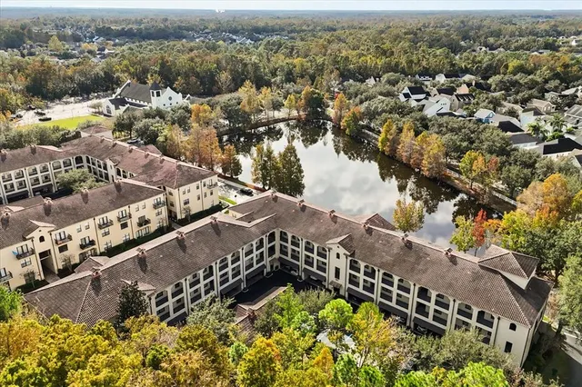 an aerial view of a house a yard and mountain