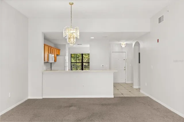 a view of a hallway with chandelier