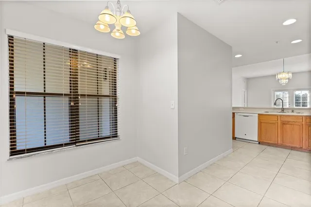 a view of kitchen with granite countertop cabinets and window