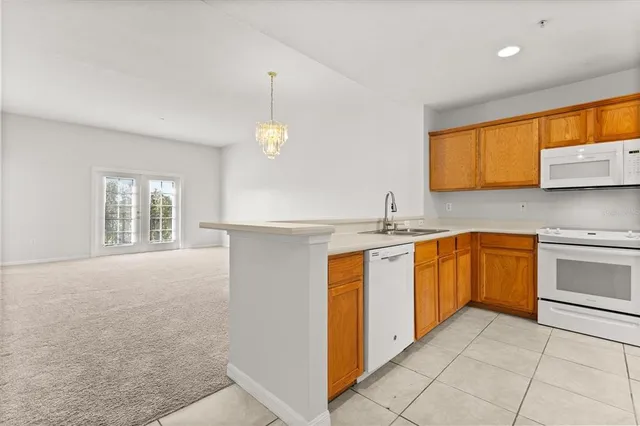 a kitchen with stainless steel appliances granite countertop a sink and a stove