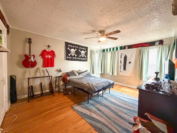 a living room with furniture a flat screen tv and a table