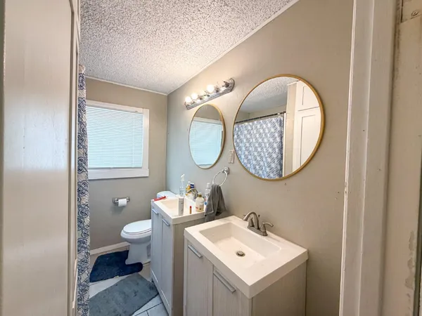 a bathroom with a toilet sink and mirror