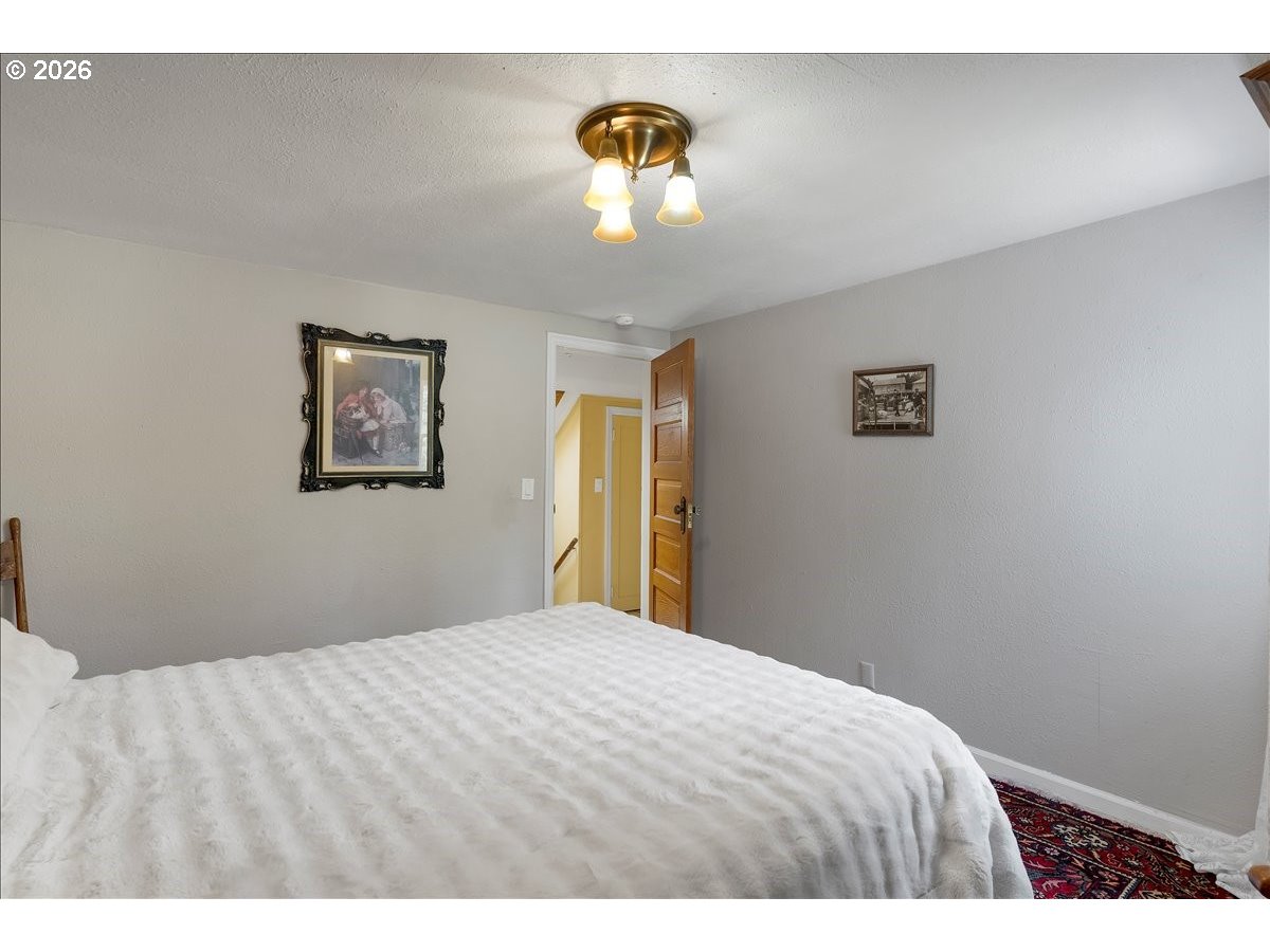 162 Riverside Drive Idanha, OR 97350 - Photo 26 of 37 a bedroom with a bed and a chandelier