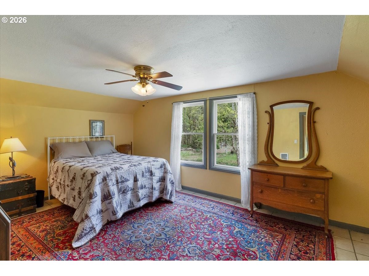 162 Riverside Drive Idanha, OR 97350 - Photo 27 of 37 a bedroom with a bed and window