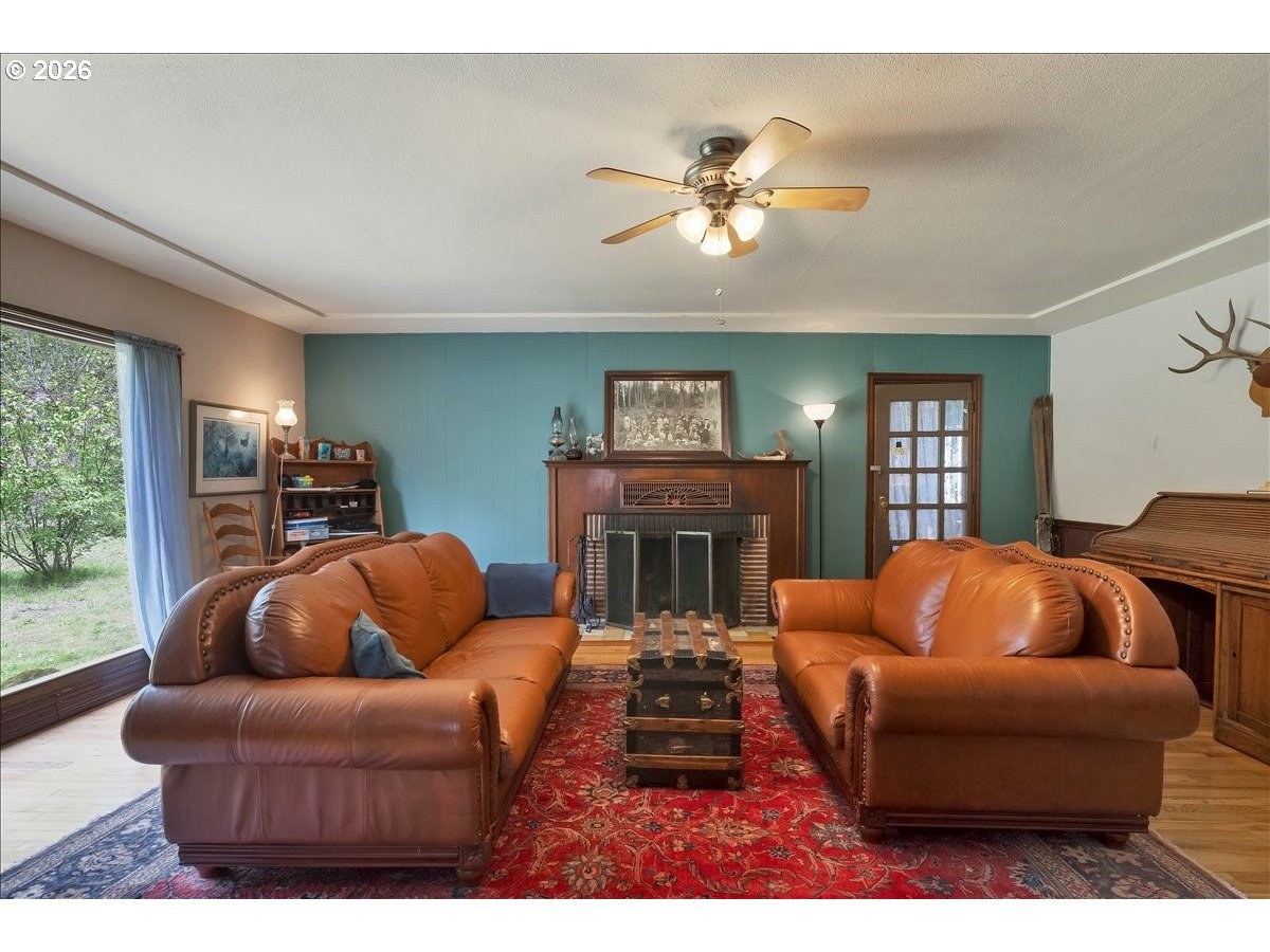 162 Riverside Drive Idanha, OR 97350 - Photo 3 of 37 a living room with furniture a ceiling fan and a window