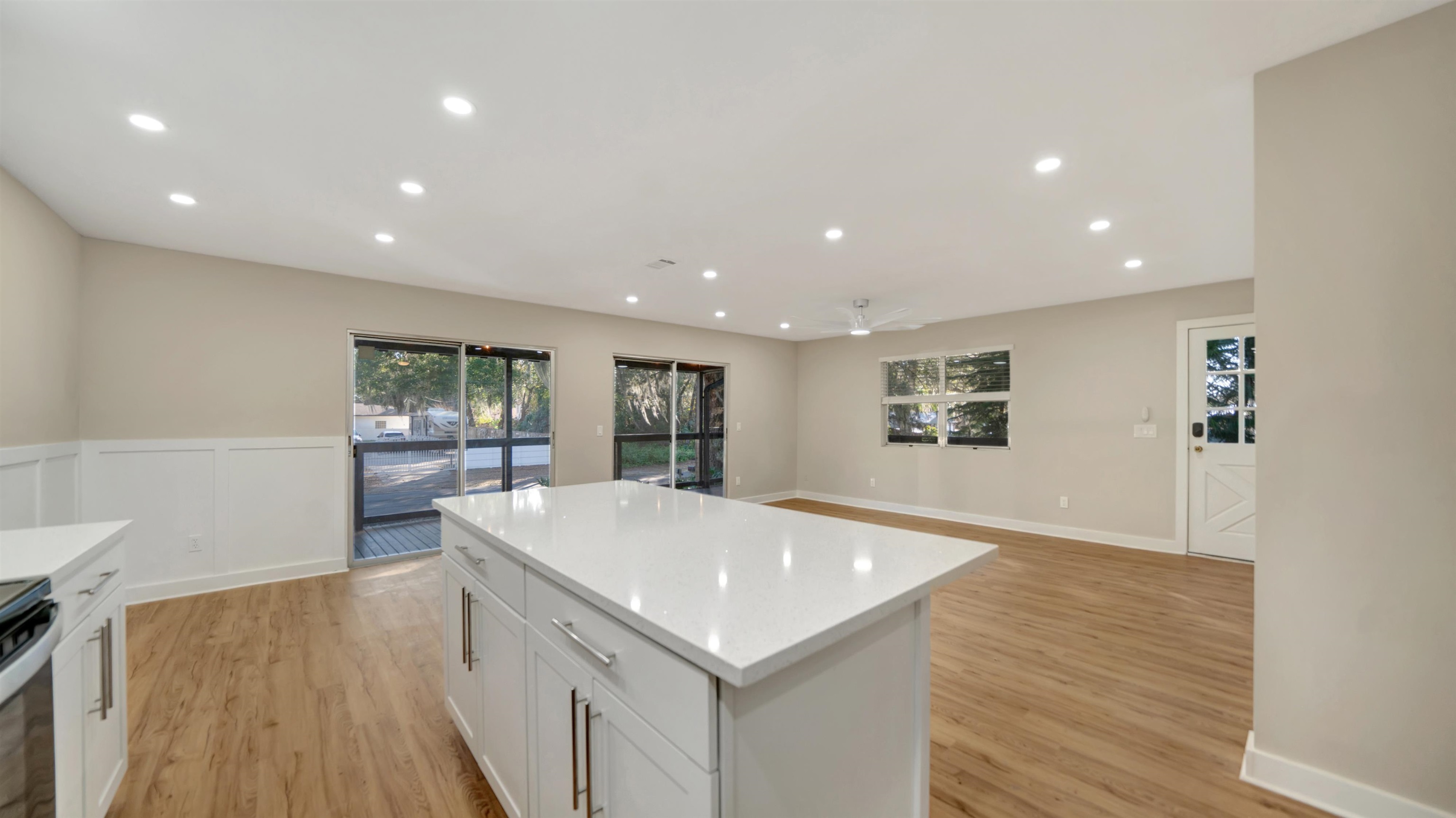114 Cardinal Road St. Augustine, FL 32086 - Photo 11 of 30 a large white kitchen with wooden floor and a sink