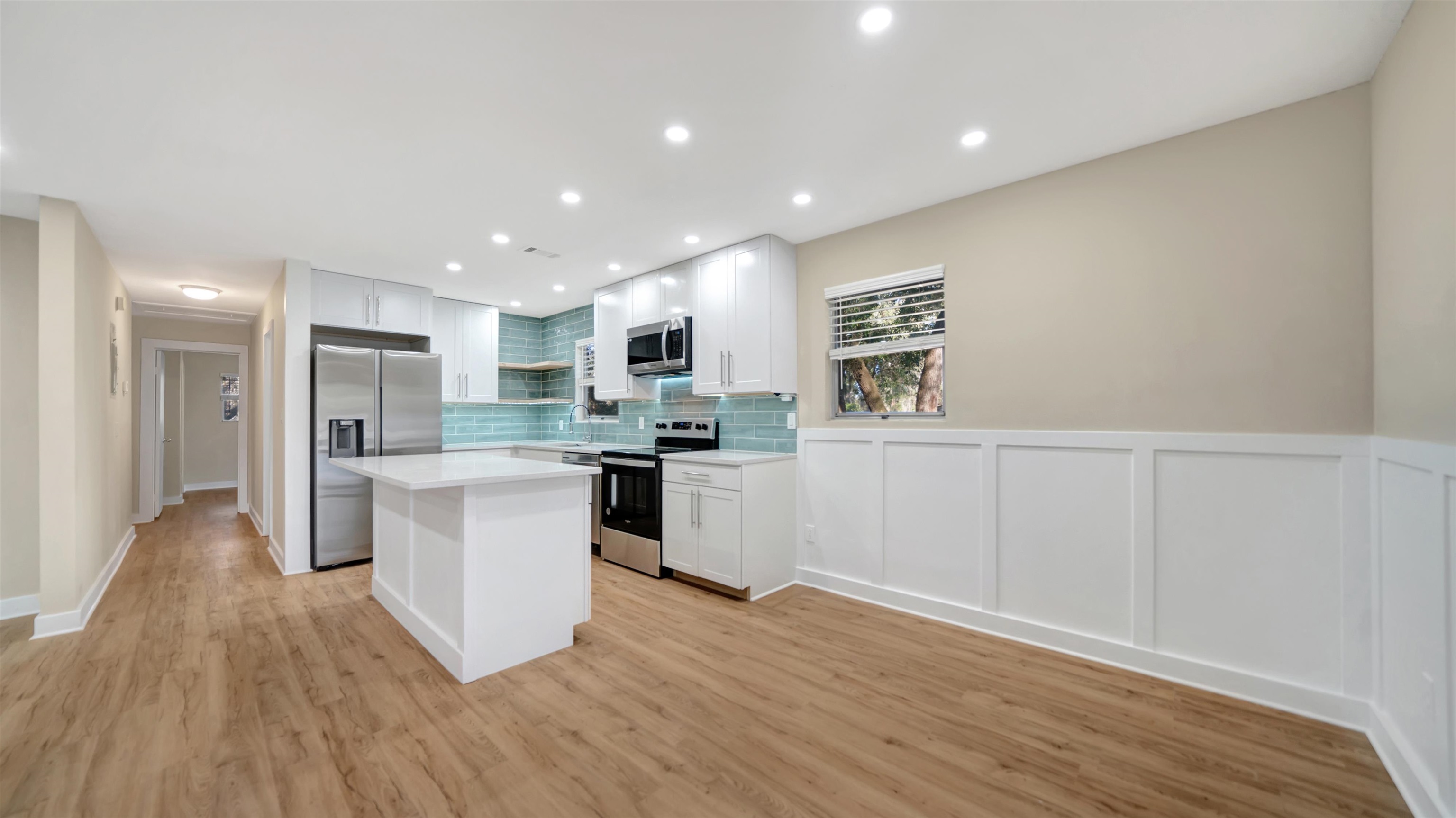 114 Cardinal Road St. Augustine, FL 32086 - Photo 10 of 30 a kitchen with white cabinets and stainless steel appliances