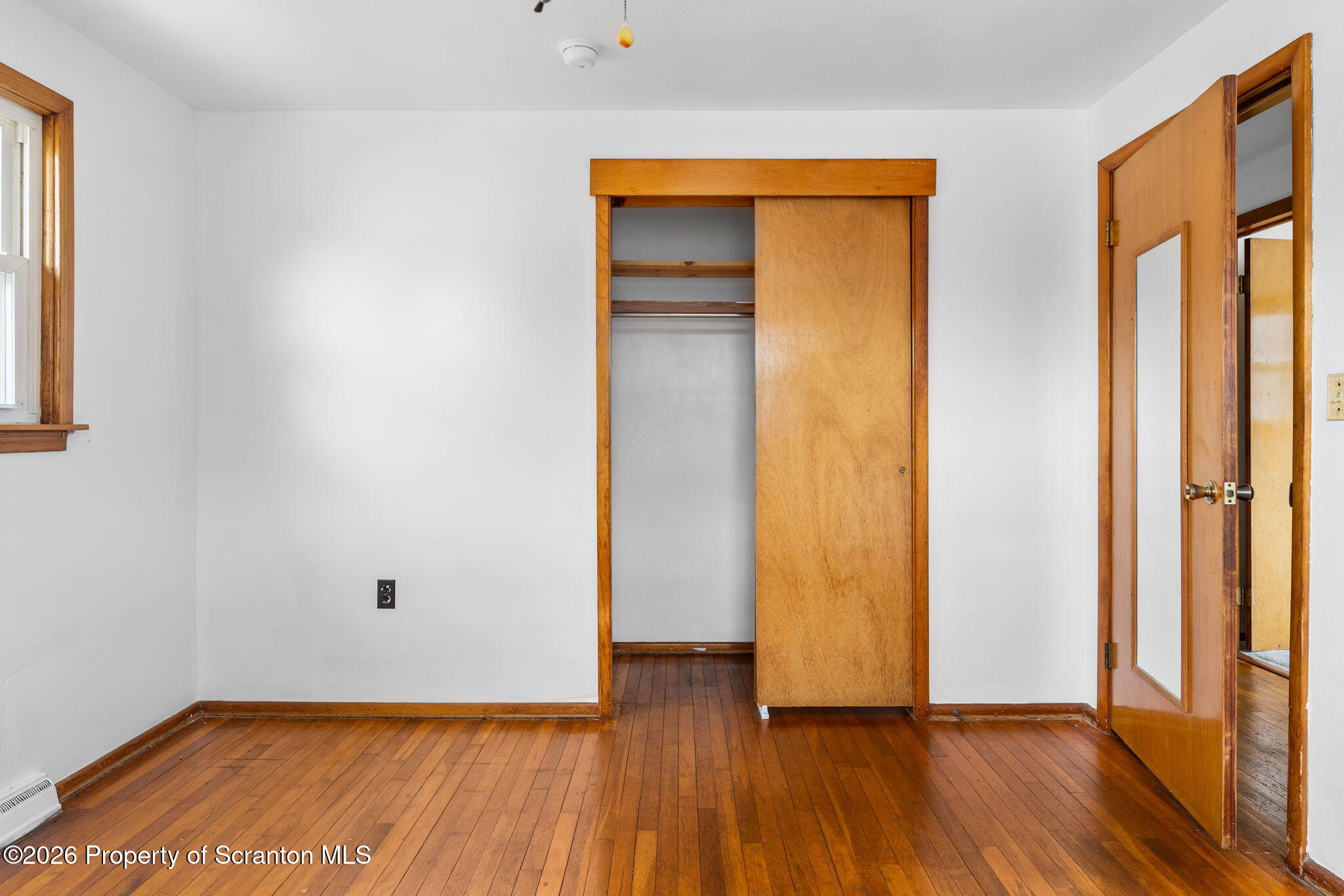 139 N Road Windsor, NY 13865 - Photo 15 of 44 an empty room with wooden floor and a window