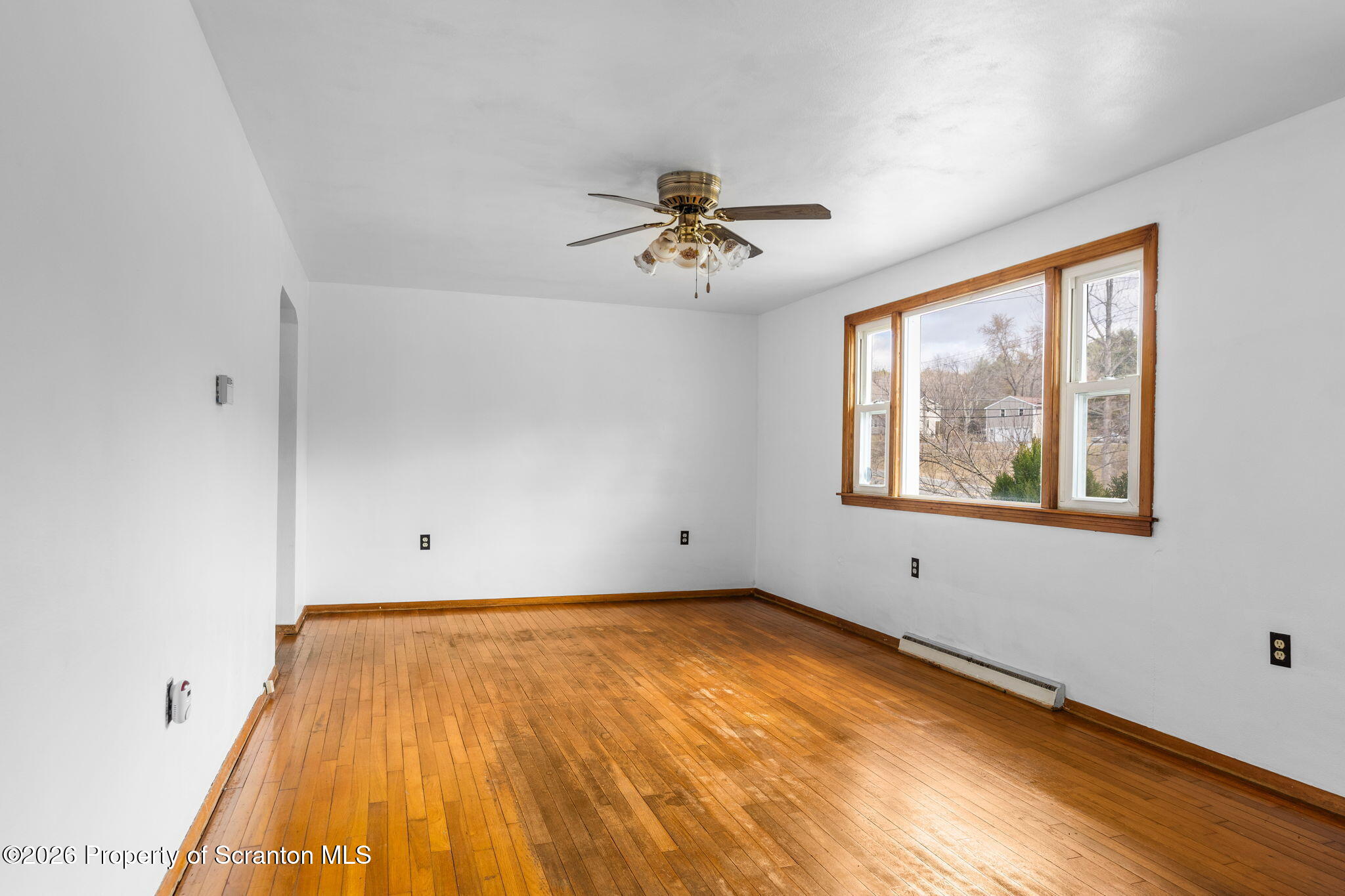 139 N Road Windsor, NY 13865 - Photo 6 of 44 a view of a room with window a ceiling fan and wooden floor